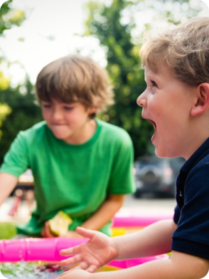 Two children playing, one in green shirt